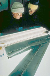 two scientists studying an ice core