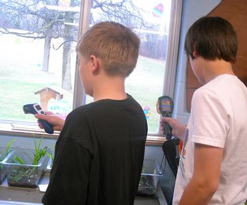 Students measure the temperatures of window materials